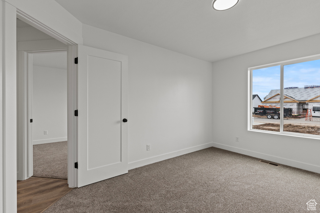 Carpeted spare room with baseboards