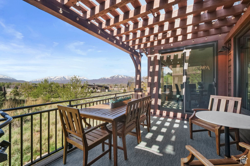 Balcony featuring a mountain view and a pergola