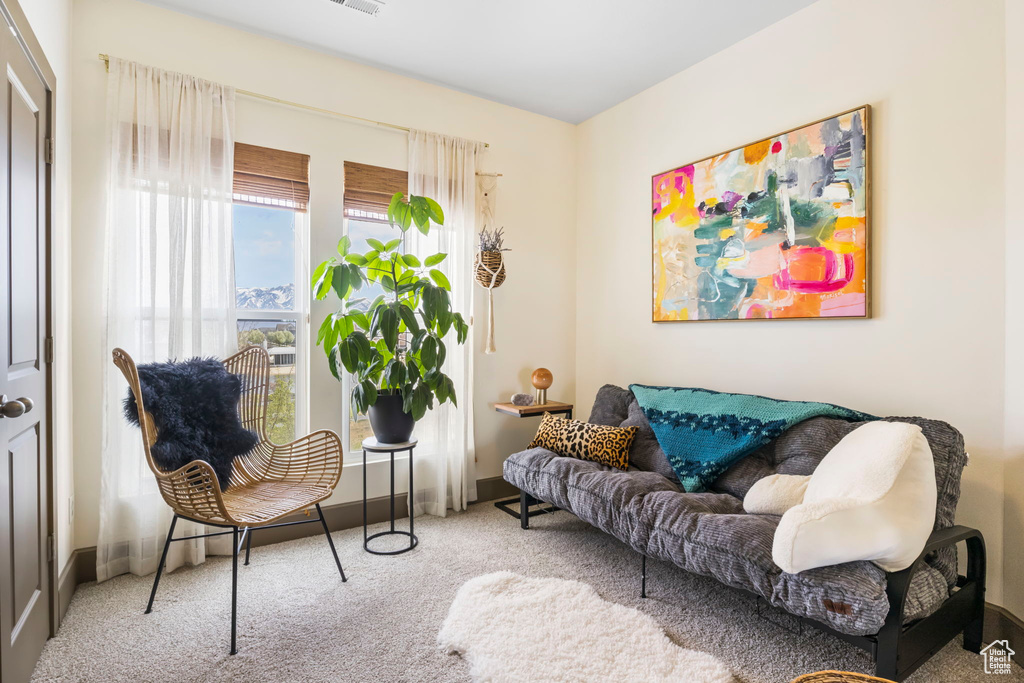 Sitting room featuring carpet and baseboards
