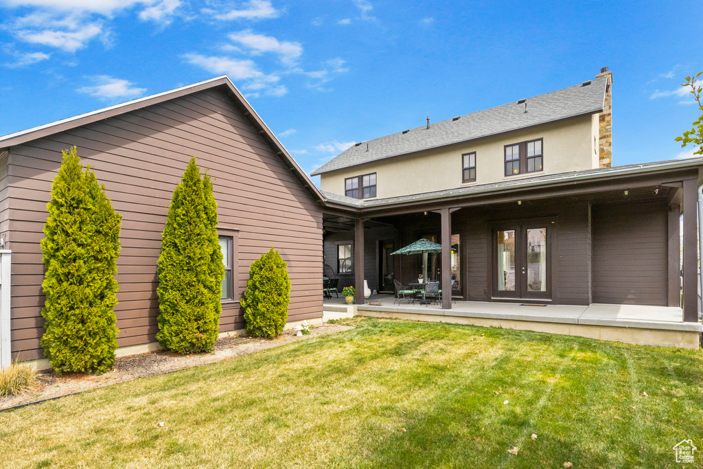 Back of house with a patio, french doors, and a lawn