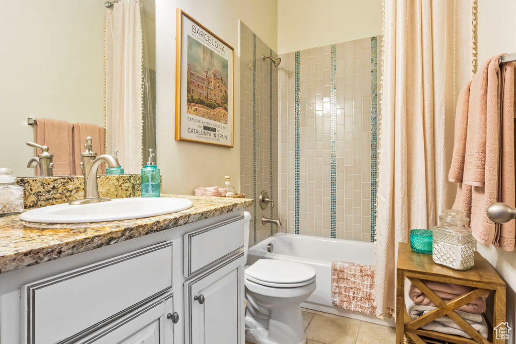 Full bath with toilet, vanity, tile patterned flooring, and shower / tub combo with curtain