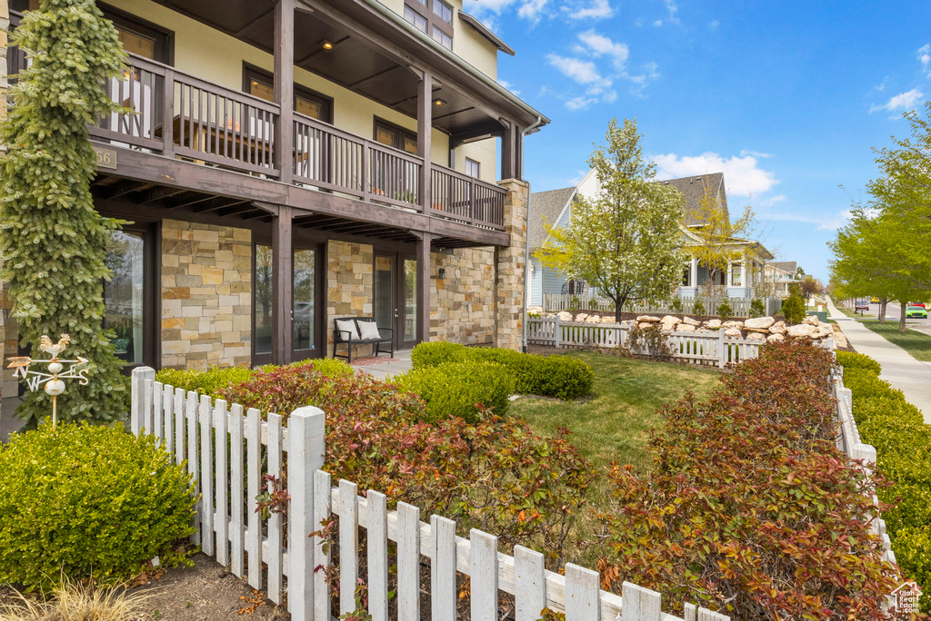 Exterior space with fence and a balcony