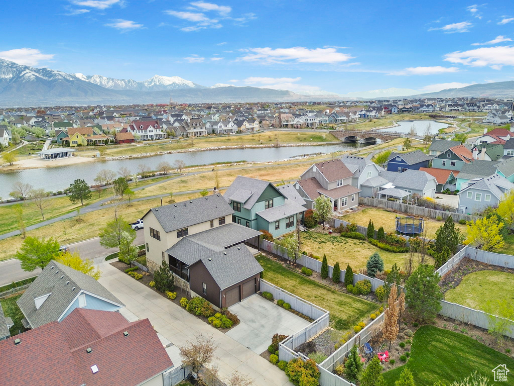 Drone / aerial view featuring a water and mountain view and a residential view