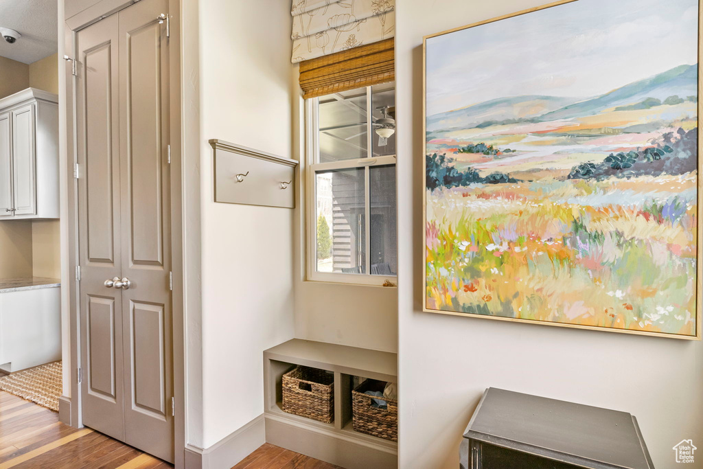 Mudroom featuring baseboards and wood finished floors