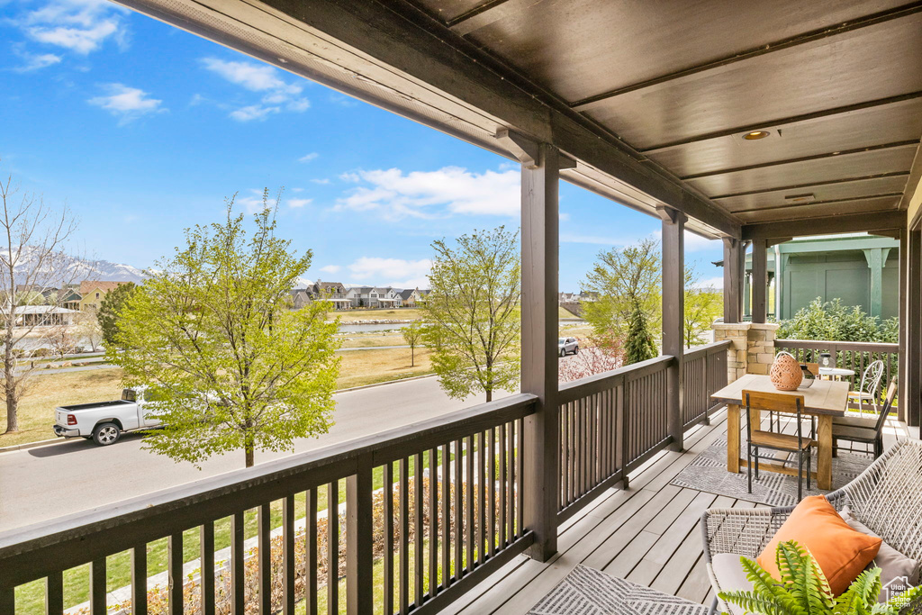 Balcony featuring a residential view and a water view