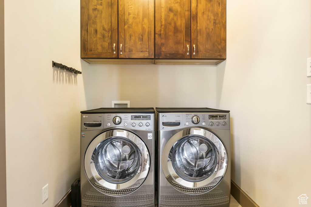 Clothes washing area with washer and dryer and cabinet space