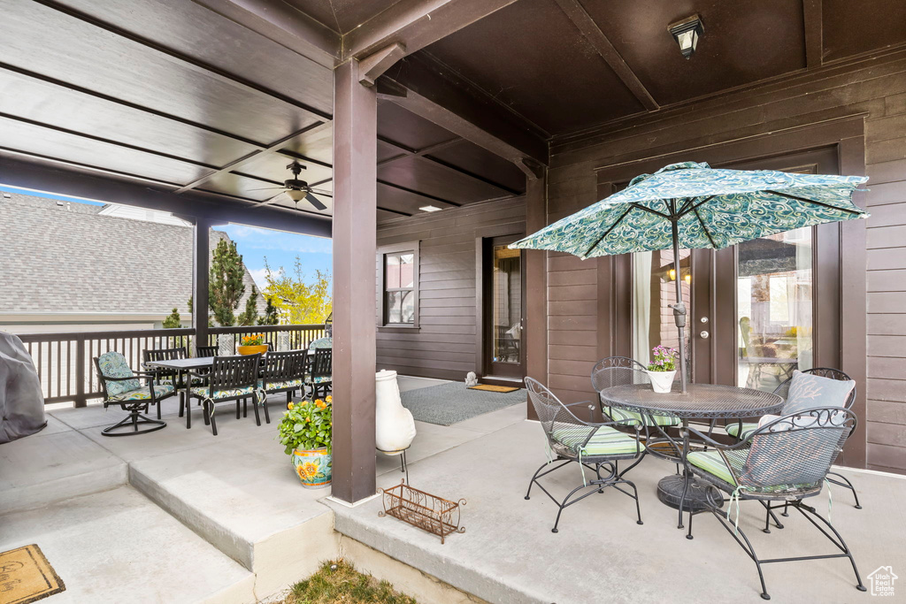 View of patio featuring outdoor dining space and ceiling fan