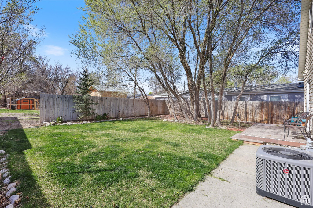 View of yard featuring a patio area, central air condition unit, and a fenced backyard