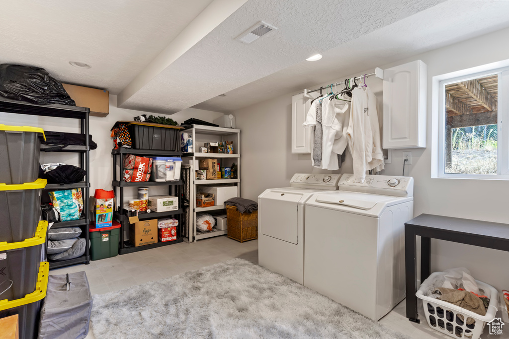 Laundry area with visible vents, washing machine and clothes dryer, cabinet space, and recessed lighting