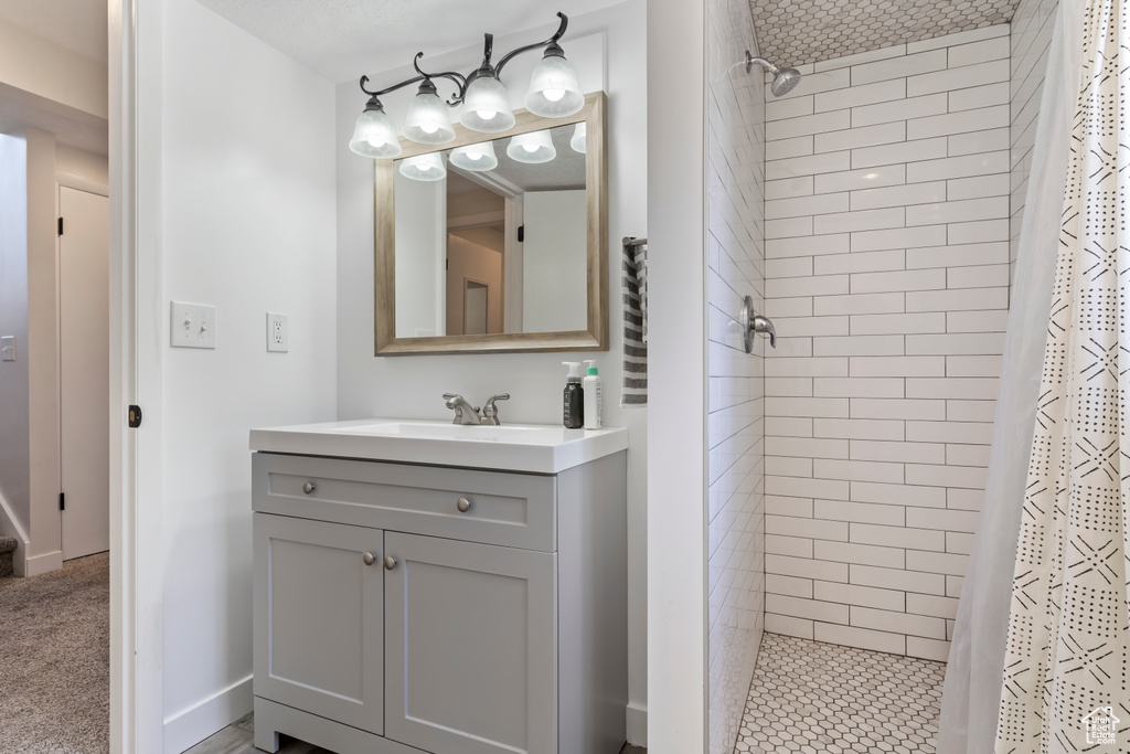 Bathroom with a shower stall and vanity