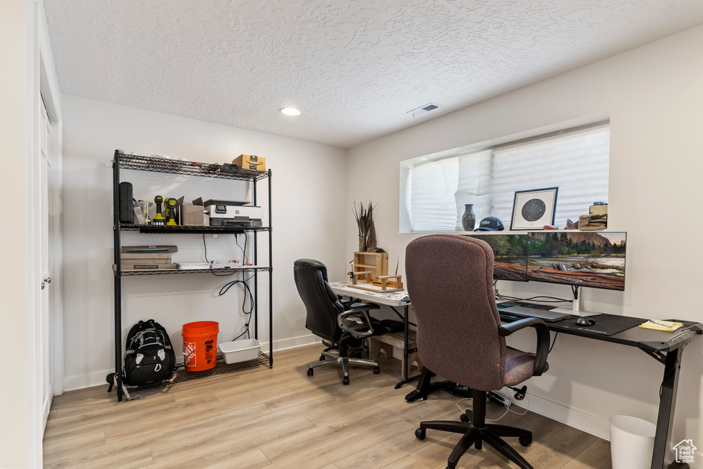 Office featuring baseboards, recessed lighting, a textured ceiling, visible vents, and wood finished floors