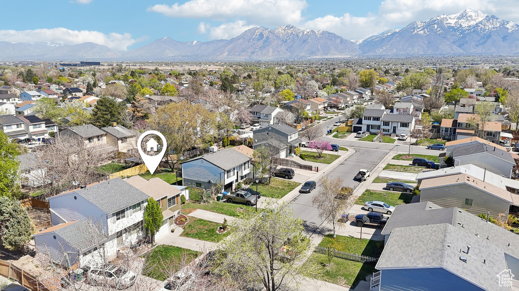 Birds eye view of property with a mountain view and a residential view