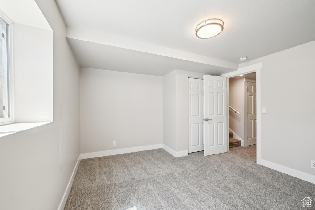 Unfurnished bedroom featuring a closet, carpet flooring, and baseboards