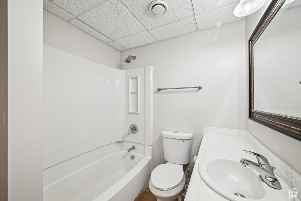 Full bathroom with bathing tub / shower combination, vanity, a paneled ceiling, and toilet