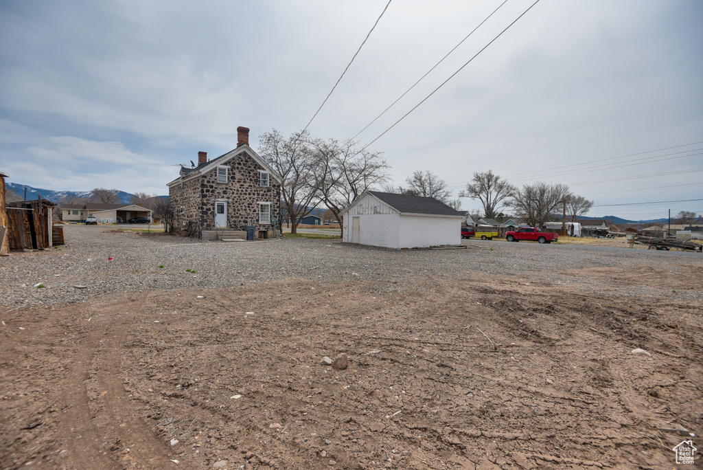 View of yard with an outbuilding and a mountain view