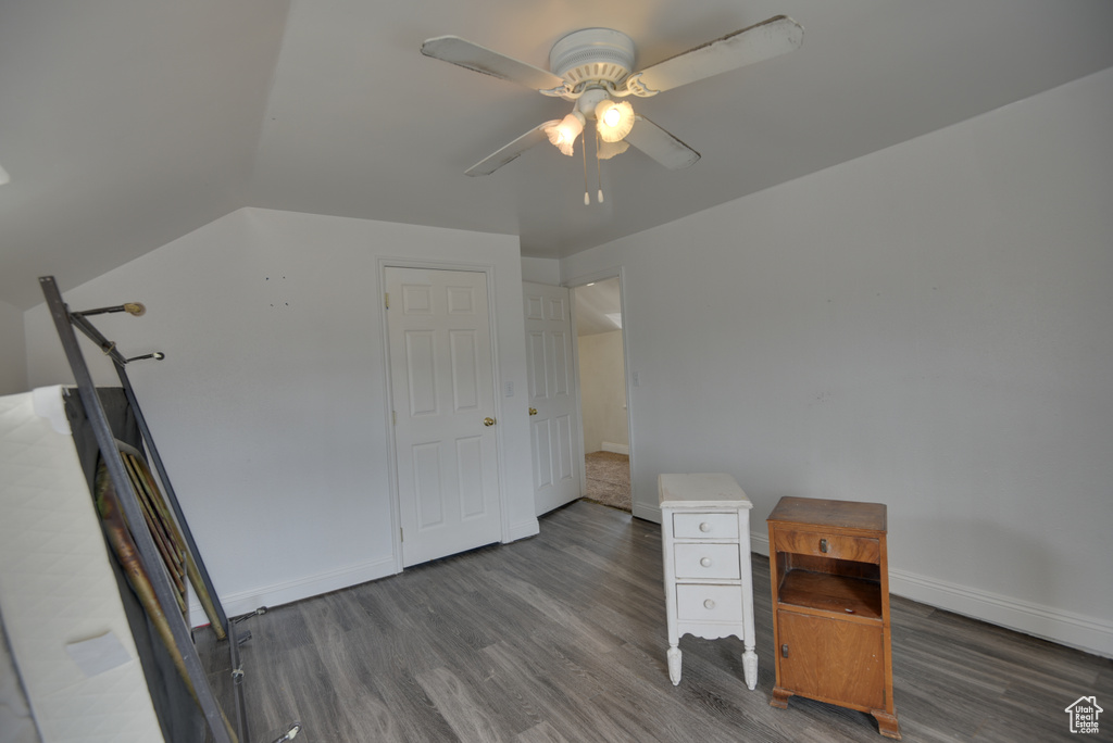 Unfurnished office with ceiling fan, baseboards, and wood finished floors