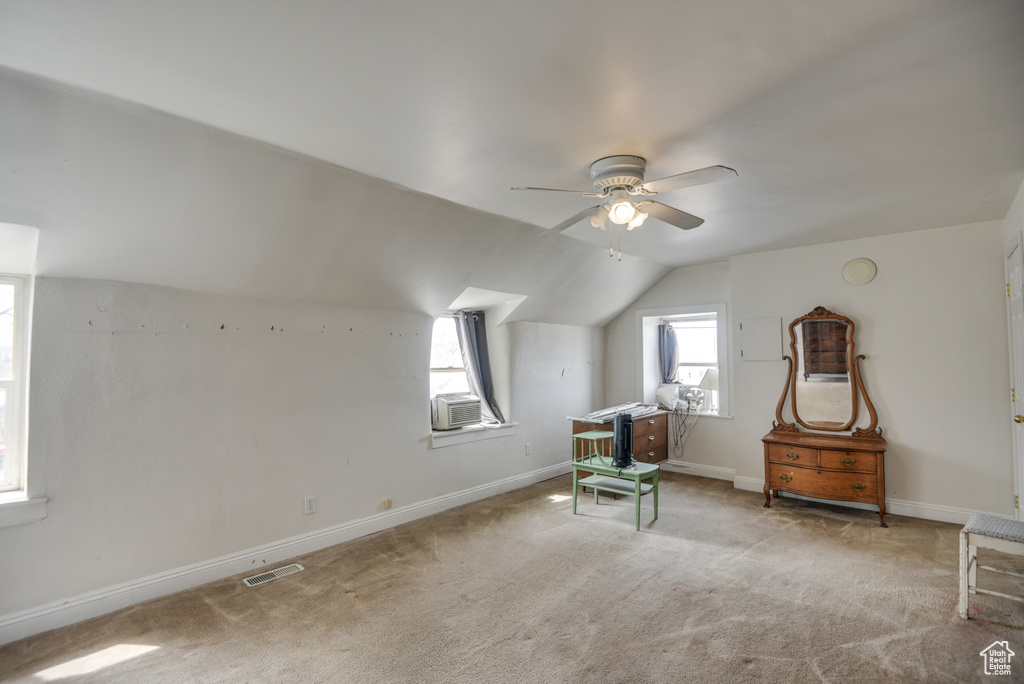 Bonus room with visible vents, ceiling fan, carpet, and a wealth of natural light