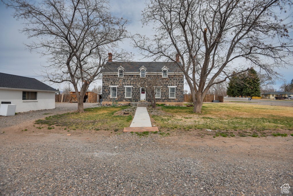 View of front of property with fence and a chimney