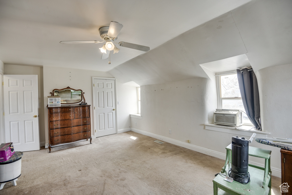 Additional living space featuring carpet, baseboards, a ceiling fan, and vaulted ceiling