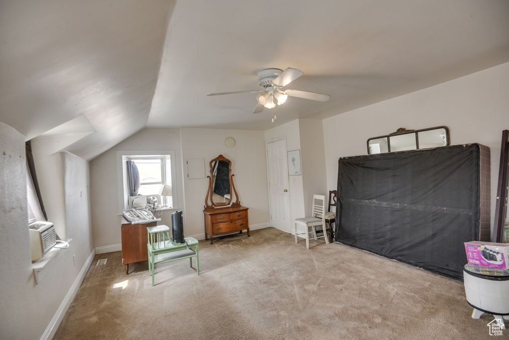 Bedroom featuring baseboards, vaulted ceiling, cooling unit, a ceiling fan, and carpet
