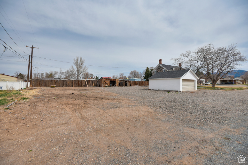 View of yard featuring fence and an outdoor structure