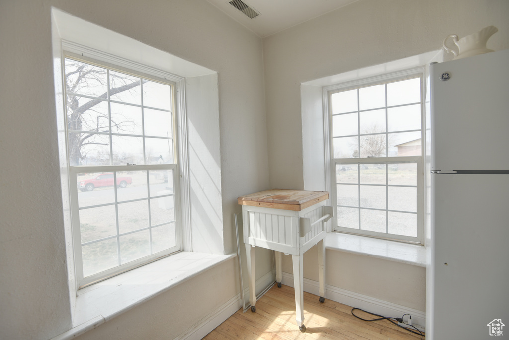 Interior space with plenty of natural light, visible vents, baseboards, and wood finished floors
