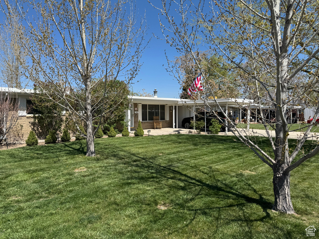 Single story home featuring a front yard and a patio