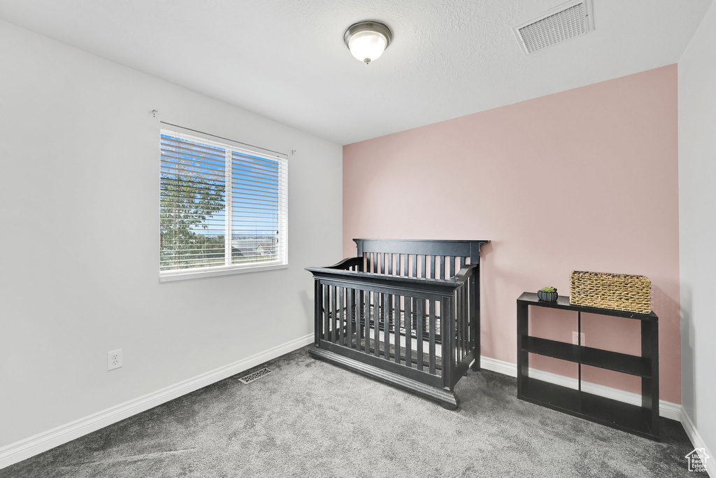 Unfurnished bedroom featuring carpet and baseboards