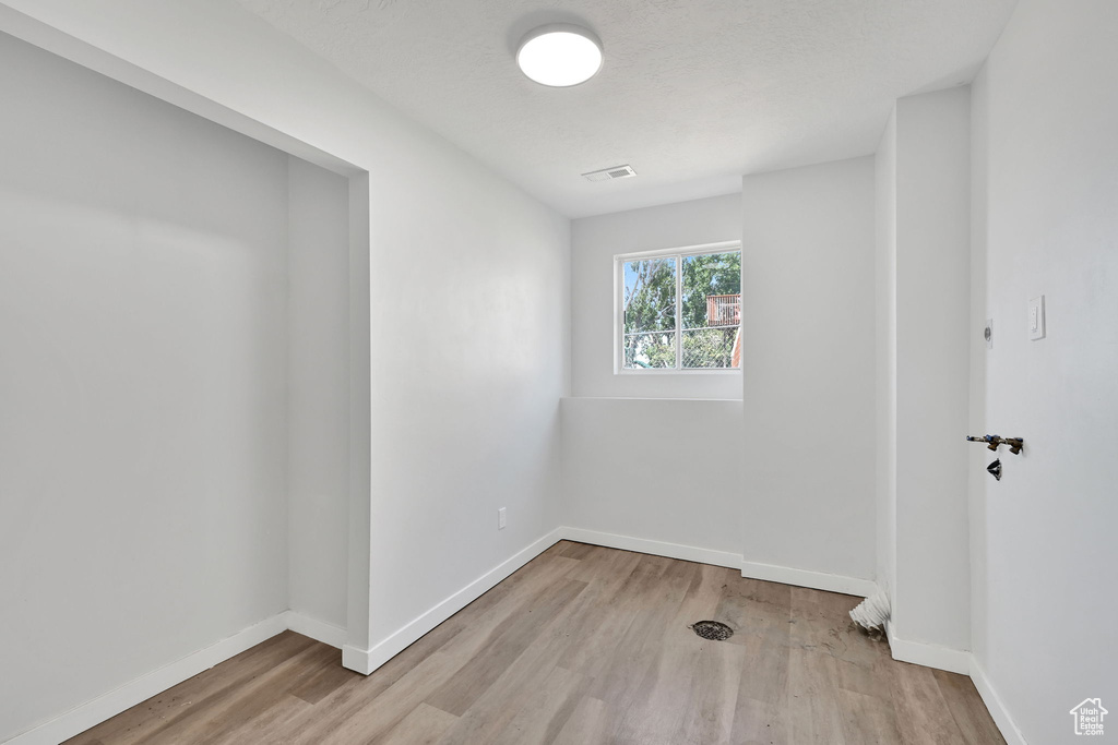 Empty room featuring wood finished floors and baseboards