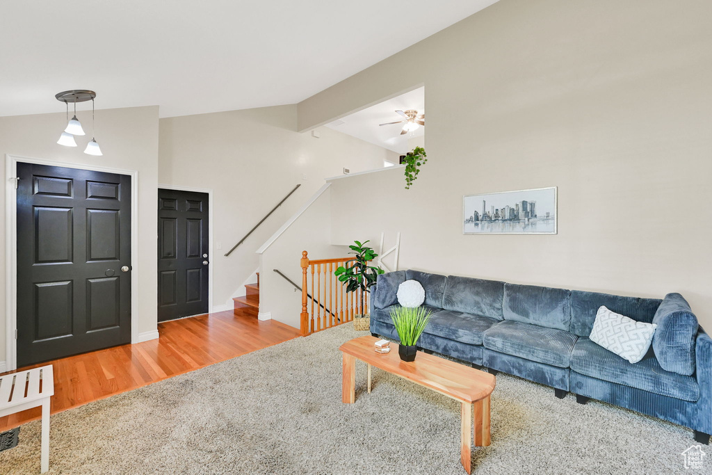 Living area featuring wood finished floors, stairs, and baseboards