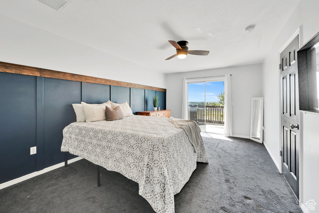Carpeted bedroom featuring access to exterior, ceiling fan, and baseboards
