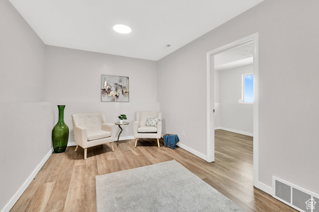 Sitting room with wood finished floors and baseboards