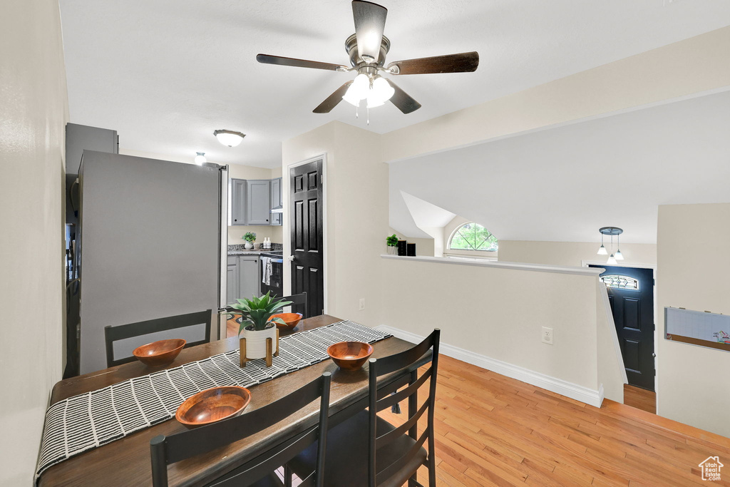 Dining space featuring light wood-style flooring, ceiling fan, and baseboards