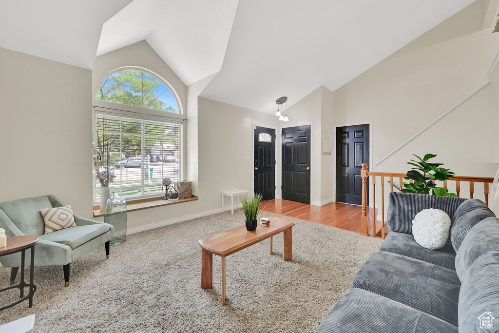 Living room with high vaulted ceiling and baseboards