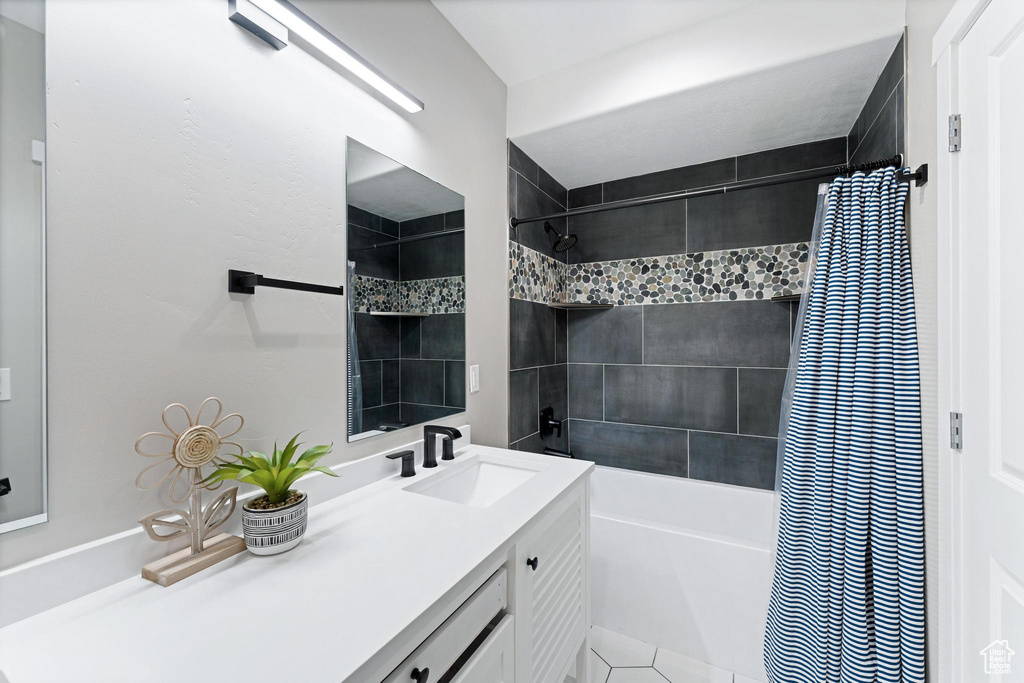 Bathroom featuring shower / tub combo and vanity