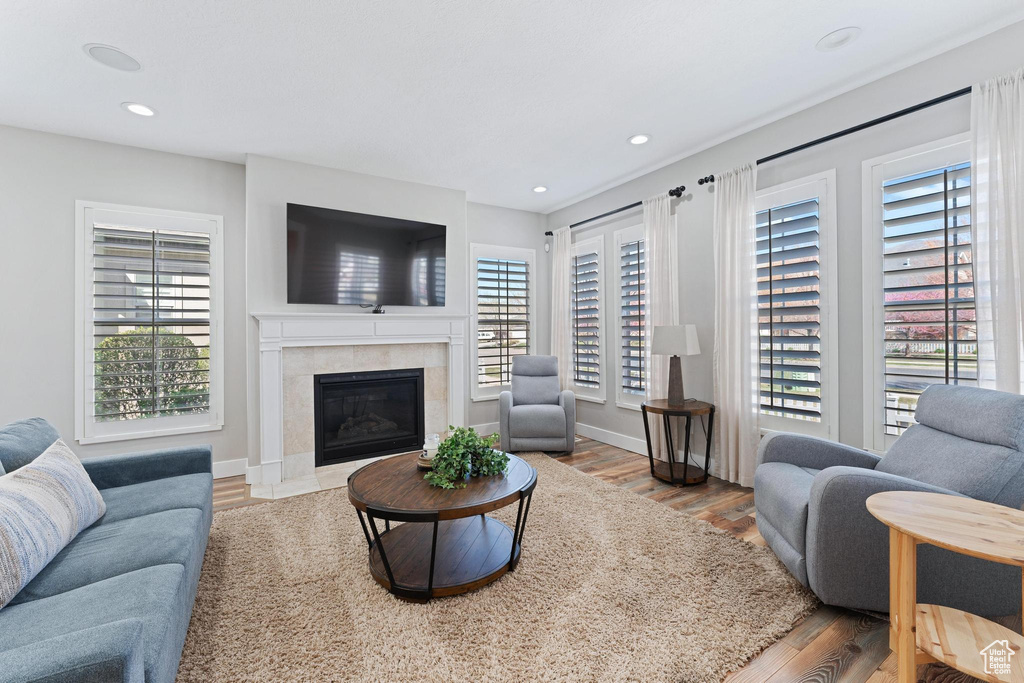 Living area with recessed lighting, plenty of natural light, and wood finished floors