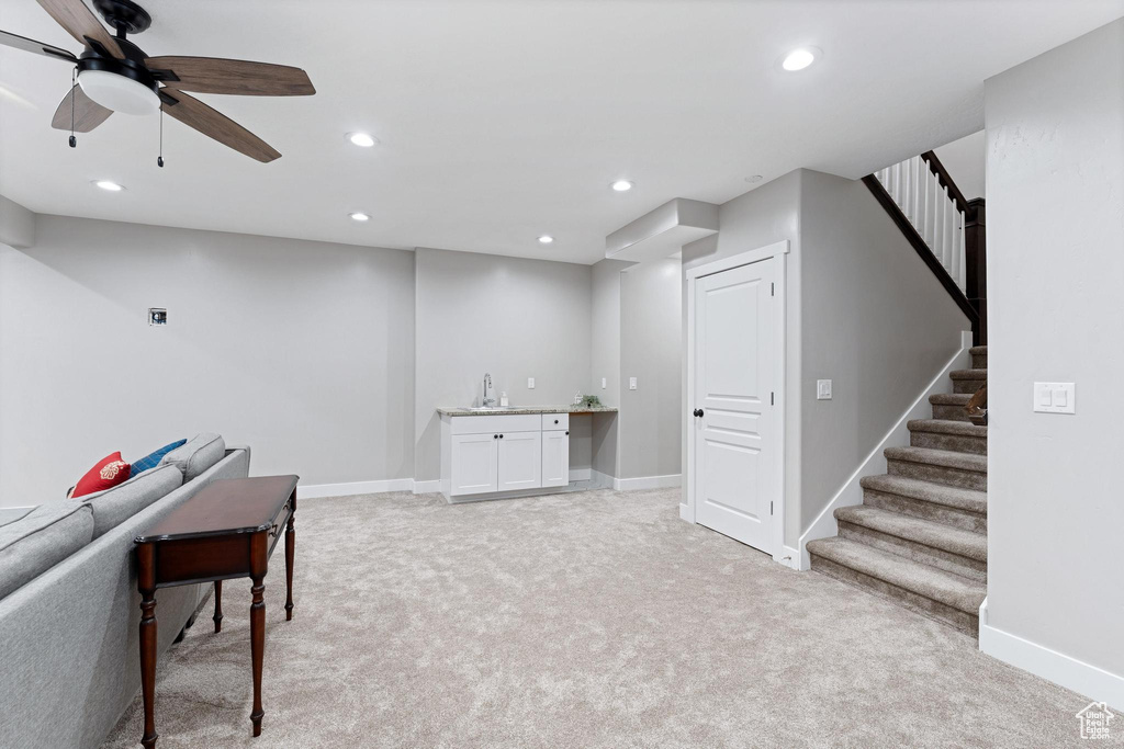 Playroom featuring a sink, baseboards, recessed lighting, and light carpet