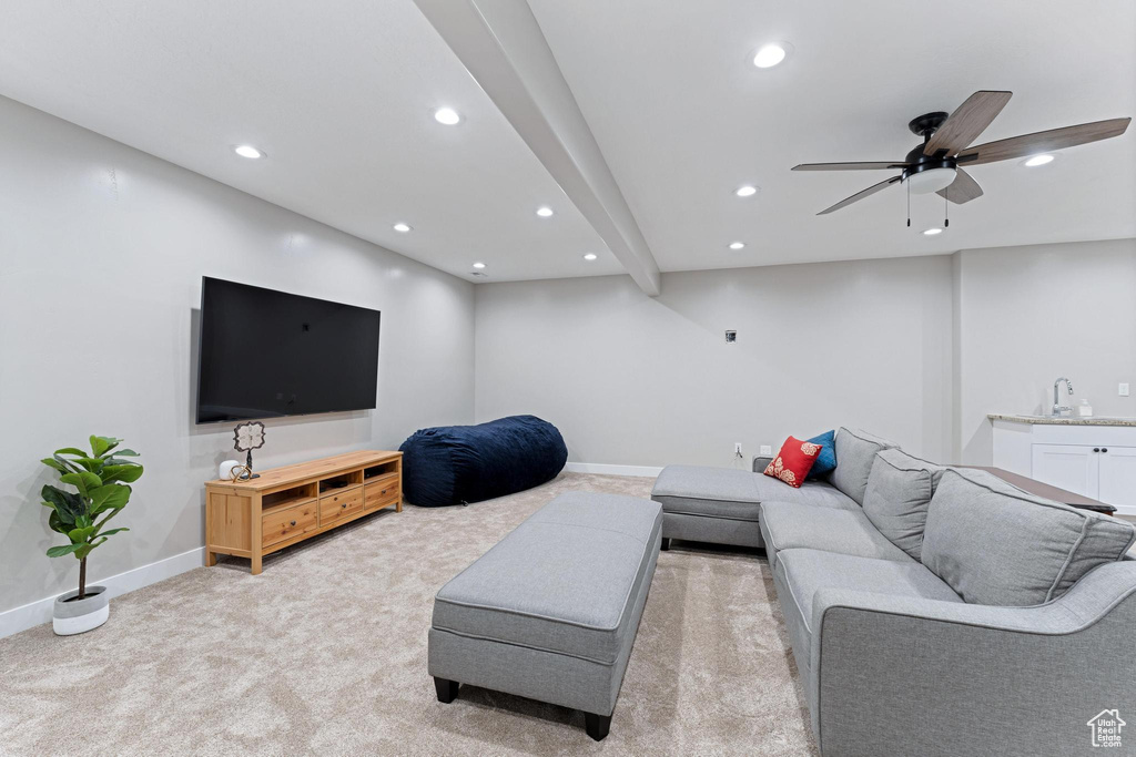 Living room with light colored carpet, baseboards, a ceiling fan, and recessed lighting