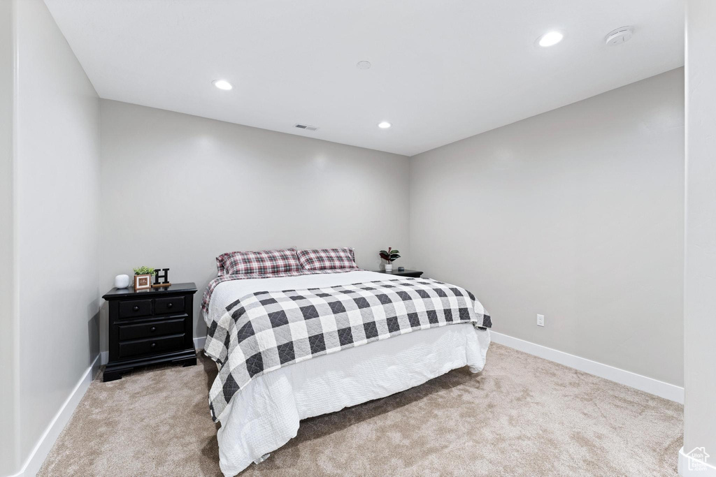 Carpeted bedroom featuring visible vents, baseboards, and recessed lighting