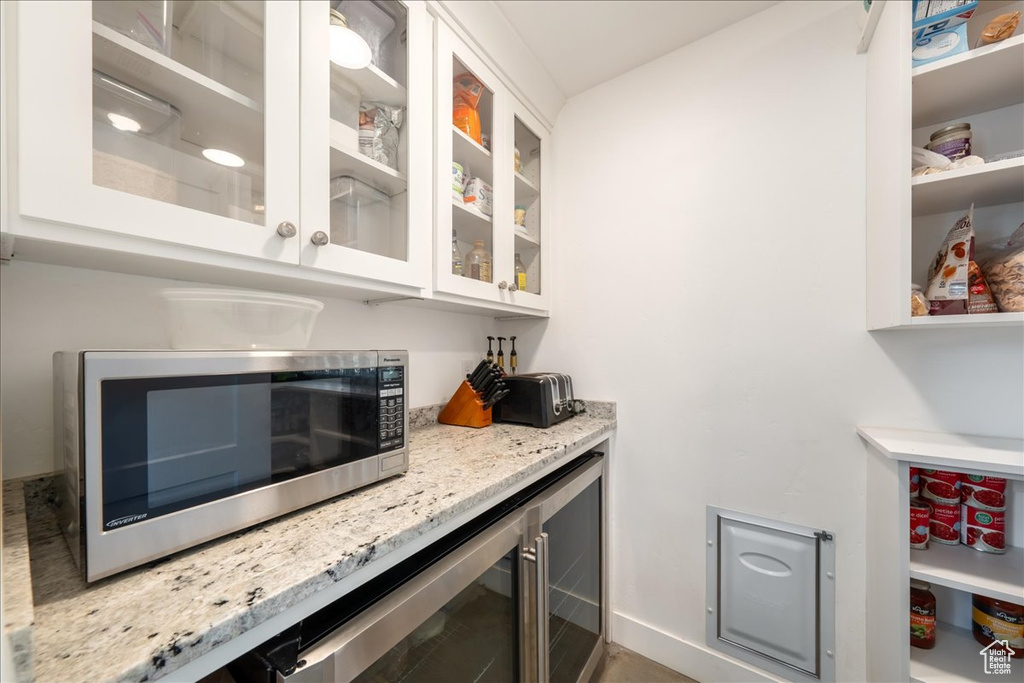 Bar featuring stainless steel microwave and beverage cooler