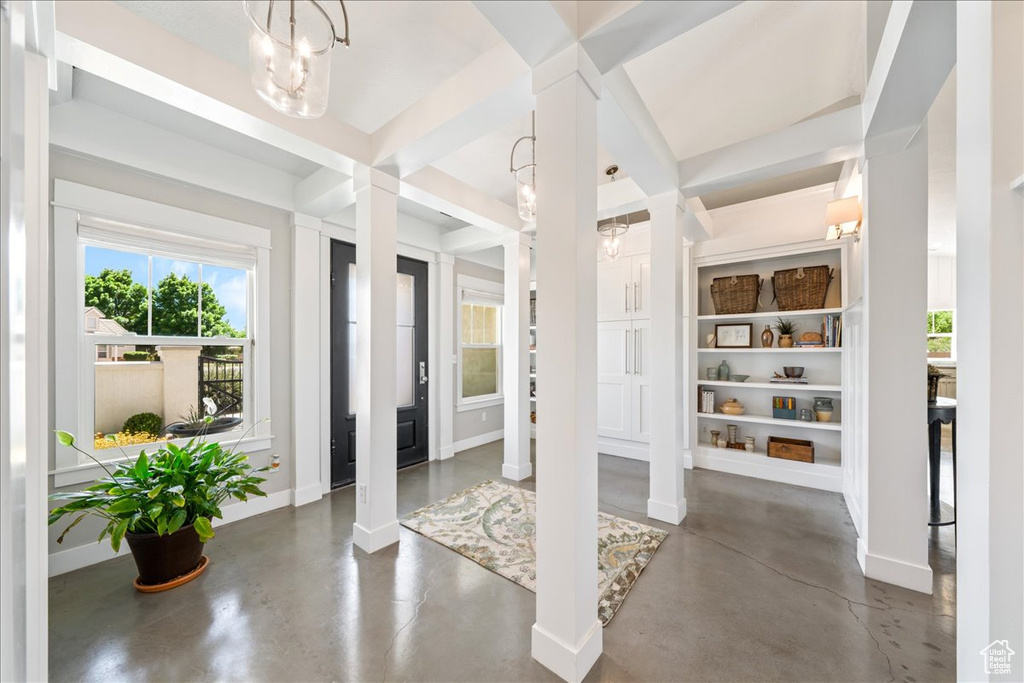 Unfurnished sunroom featuring an inviting chandelier