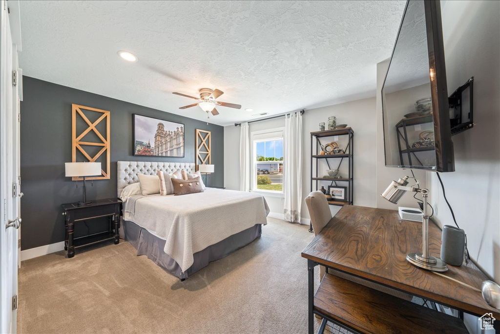 Bedroom with baseboards, light carpet, recessed lighting, a textured ceiling, and a ceiling fan