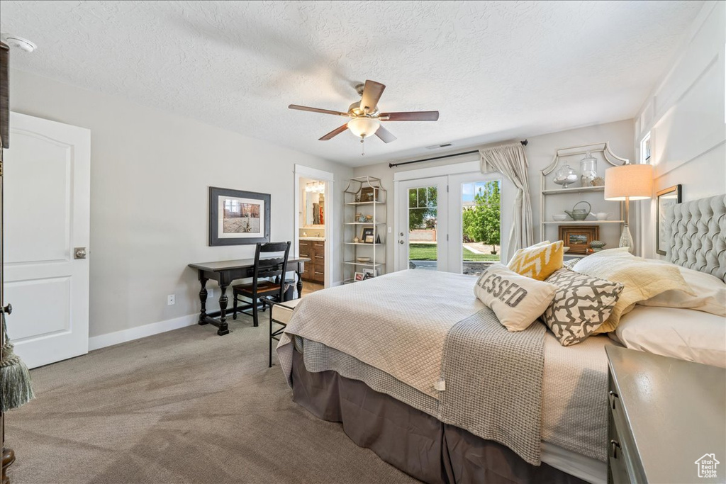 Bedroom with baseboards, a textured ceiling, carpet floors, french doors, and access to exterior