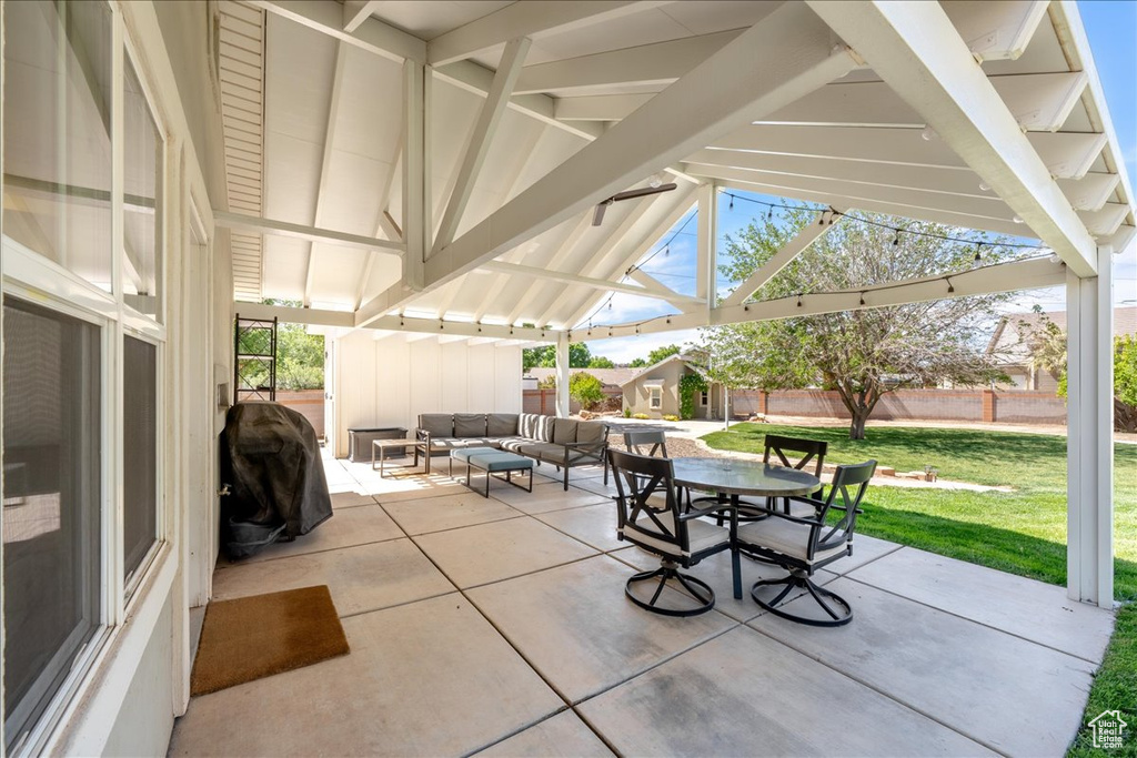View of patio with an outdoor living space, outdoor dining space, a fenced backyard, and a grill