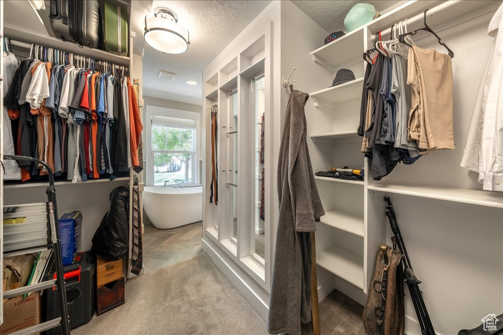 Spacious closet featuring visible vents