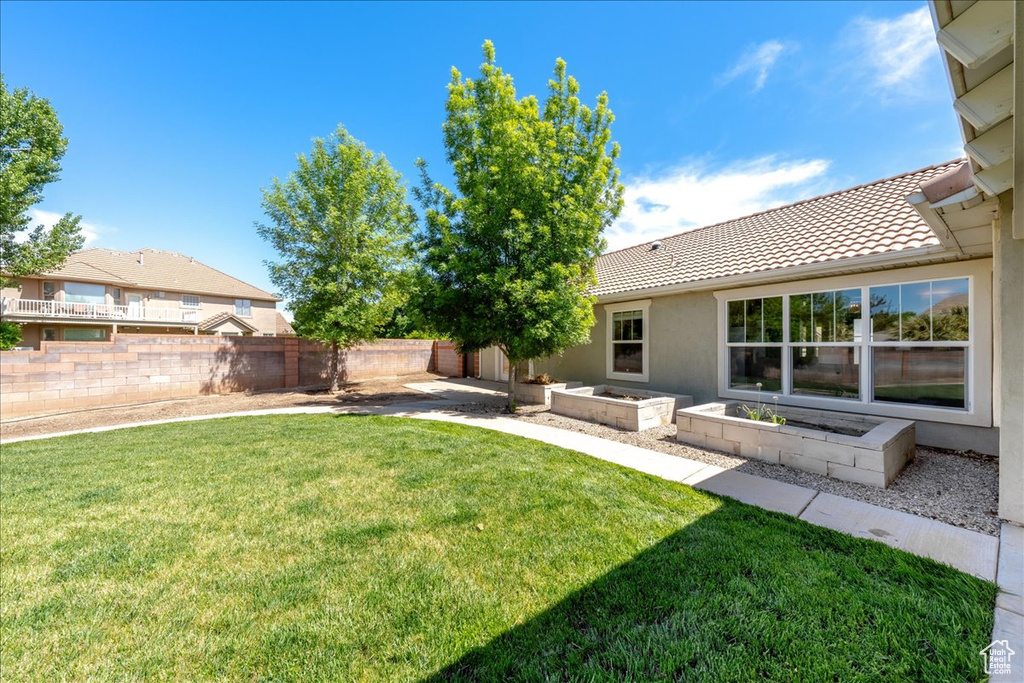 View of yard with a garden and a fenced backyard