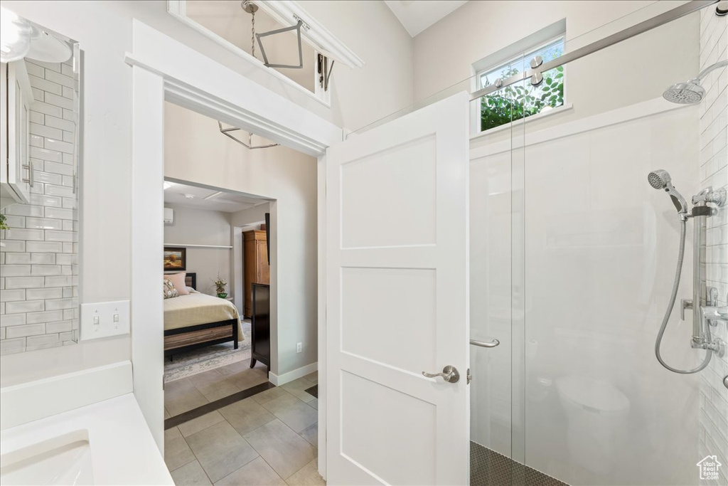 Ensuite bathroom featuring tile patterned floors, a shower stall, and ensuite bath
