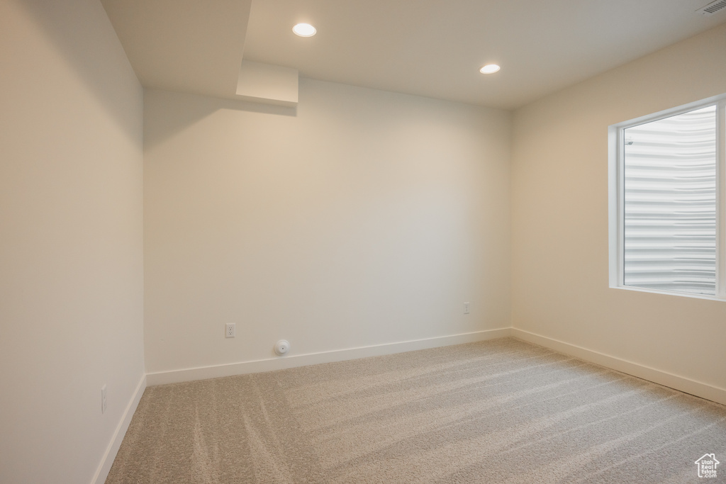 Unfurnished room with light colored carpet, baseboards, and recessed lighting