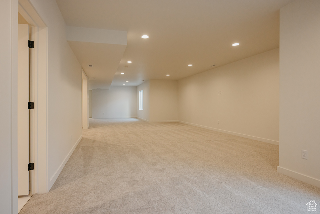 Basement with light carpet, recessed lighting, and baseboards