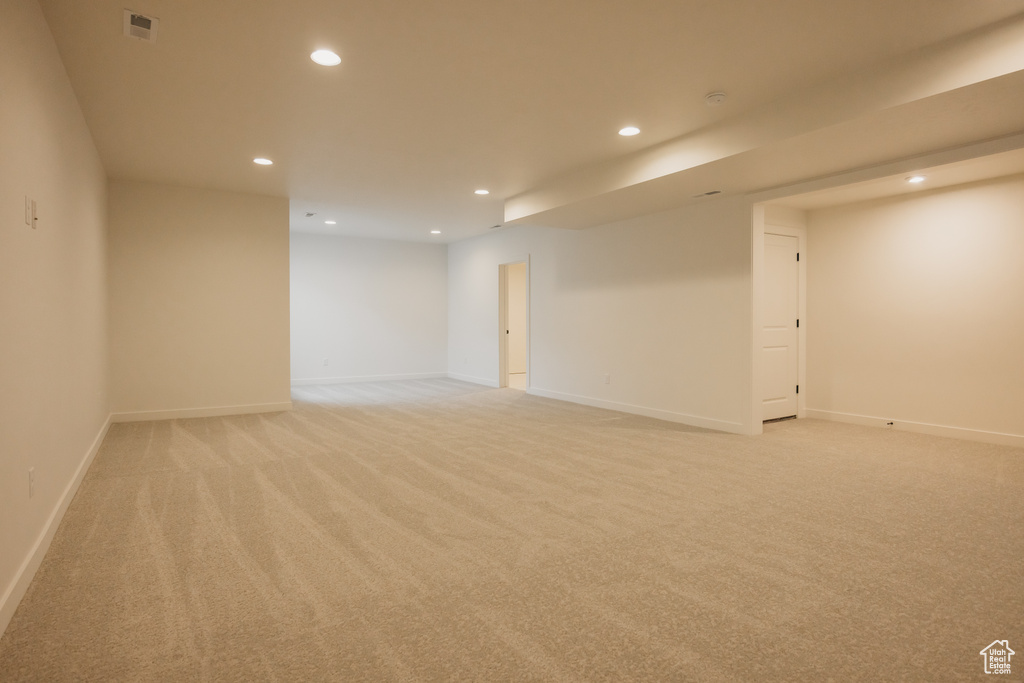 Unfurnished room with recessed lighting, light carpet, and baseboards